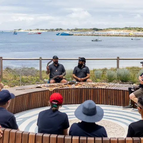A group in a cultural yarn on Wadjemup hosted by the Mirliny Cultural Yarning Experience